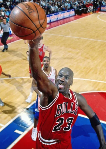 Michael Jordan goes up for a dunk against the Philadelphia 76ers in 1996. Photograph: Nathaniel S Butler/NBAE